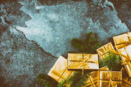 Christmas background. Golden gift boxes on slate background. Flat lay, top viewの写真素材
