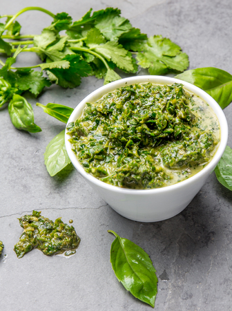 Green chimichurri parsley basil sauce. Slate backgroundの写真素材
