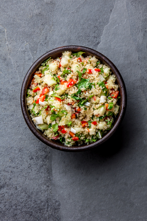 Traditional peruvian quinoa quinua salad in clay bowl, slate gray backgroundの写真素材