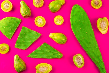 Creative layout made of mexican cactus leaves and cactus fruits pricly pear or tuna on red background. Flat lay. Mexican, Latin American food concept.の写真素材
