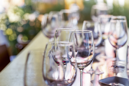 Wineglasses with white and red wine on degustation tableの写真素材