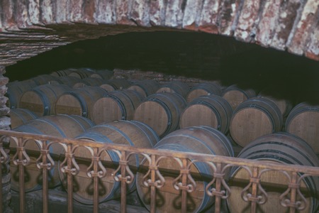 Wine barrels in a old cellar at winery. Wooden barrels of wine in vineyard.の写真素材