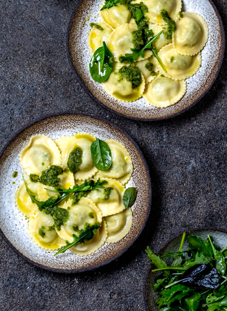 Italian spinach ricotta ravioli, Top view, black background, copy space, Vegetarian food, vegan ravioliの写真素材