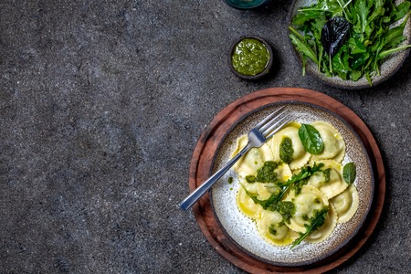 Italian spinach ricotta ravioli, Top view, black background, copy space, Vegetarian food, vegan ravioliの写真素材