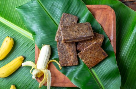 Easter Island Tahitian Polynesian banana pie pupping POE on wooden plate on banana palm tree leaves.の写真素材