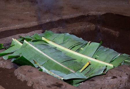 Easter Island tipical food Fish tuna, seafood, chicken, meat and camote prepared over hot stone and covered with banan tree leaves. Curanto rapa nui.の写真素材