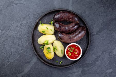 Spanish and Argentine MORCILLA blood sausages with potatoes and chili sauceの写真素材