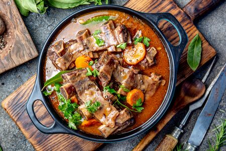 Bourguignon beef ribs stewed with onion, carrot in red wineの写真素材