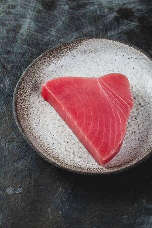 Raw fresh TUNA STEK on gray plate. Black backgroundの写真素材