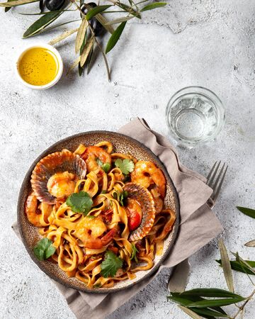 Seafood Spaghetti with seashells, prawns, squids on gray background. Italian mediterranean food concept.の写真素材