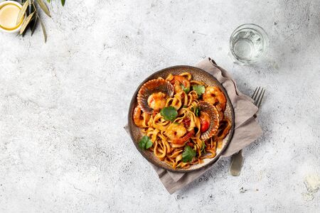 Seafood Spaghetti with seashells, prawns, squids on gray background. Italian mediterranean food concept.の写真素材
