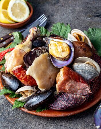 Famous traditional dish of the south of Chile and the Chiloe archipelago - Curanto Kuranto.  Different seafood and meat cooked in a pit on the coals under the ground.の写真素材