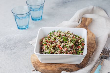 Quinoa Quinua salad with tomatoes and herbs in white bowl.の写真素材