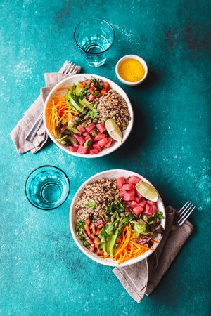 Vercion of Hawaiian tuna poke bowl with quinoa. tropical background.の写真素材