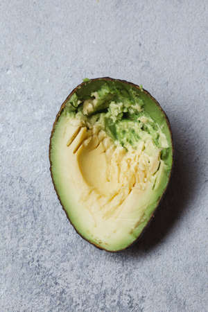 Half avocado on gray concrette background. Top viewの写真素材