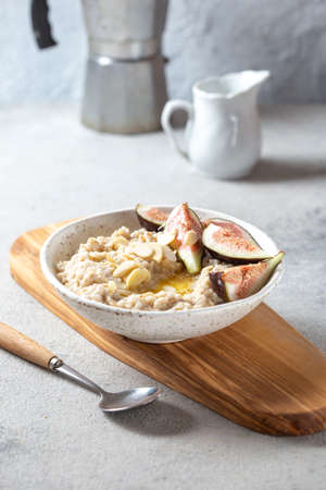 Healthy Oatmeal with figs. Coffee, oatmeal breakfast conceptの写真素材