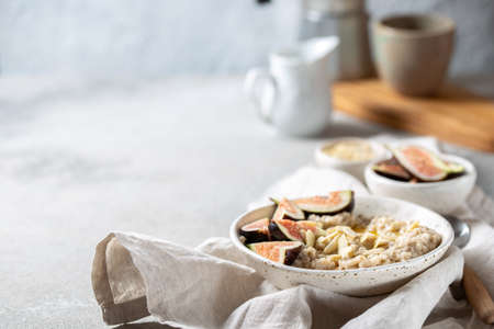 Healthy Oatmeal with figs. Coffee, oatmeal breakfast conceptの写真素材