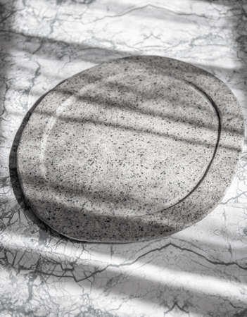 Raw ossobuco on stone gray plate, sunlight immitation
