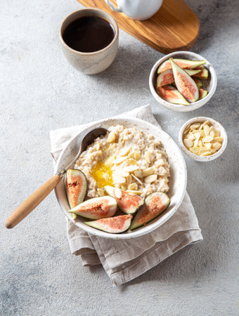 Healthy Oatmeal with figs. Coffee, oatmeal breakfast conceptの写真素材