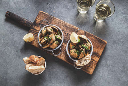 Two pan witn clams in white wine with herbs. Top viewの写真素材