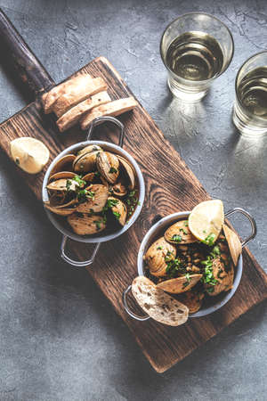 Two pan witn clams in white wine with herbs. Top viewの写真素材