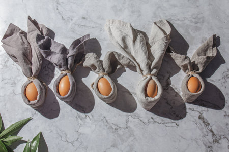 Festive easter background with Easter bunny eggs on linen napkin. Easter decoration, top view. Copy space.の写真素材