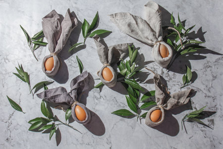 Festive easter background with Easter bunny eggs on linen napkin. Easter decoration, top view. Copy space.の写真素材