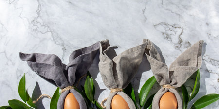 Festive easter background with Easter bunny eggs on linen napkin. Easter decoration, top view. Copy space.の写真素材