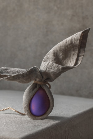 Easter background with Easter bunny made from eggs and linen napkin. Festive easter home table decorationter home table decorationの写真素材