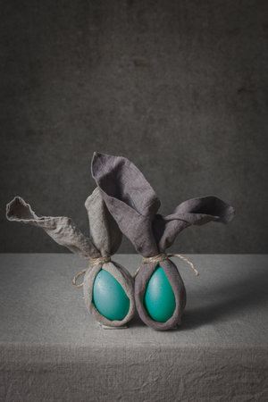 Easter background with Easter bunny made from eggs and linen napkin. Festive easter home table decorationter home table decorationの写真素材
