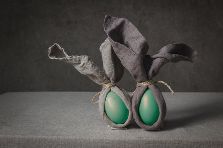 Easter background with Easter bunny made from eggs and linen napkin. Festive easter home table decorationter home table decorationの写真素材
