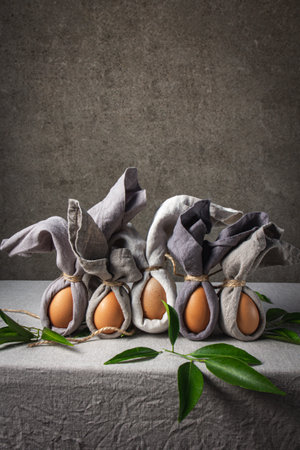 Easter background with Easter bunny made from eggs and linen napkin. Festive easter home table decorationter home table decorationの写真素材