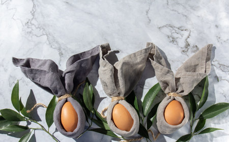Festive easter background with Easter bunny eggs on linen napkin. Easter decoration, top view. Copy space.の写真素材