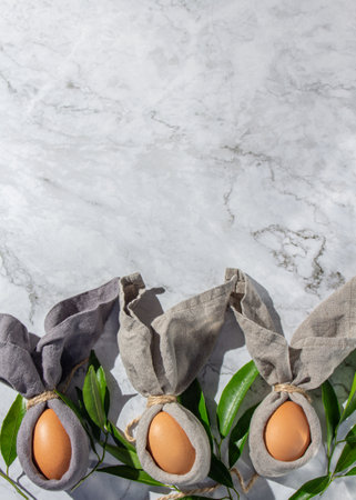 Festive easter background with Easter bunny eggs on linen napkin. Easter decoration, top view. Copy space.の写真素材