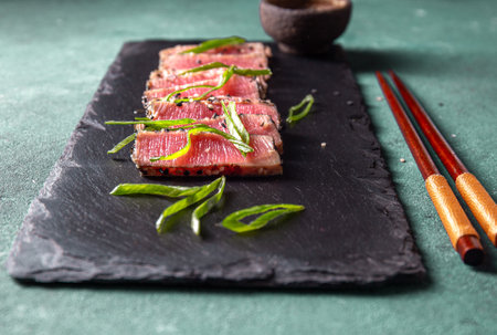Japanese food. Tuna tataki. Raw tuna sashimi on black boardの写真素材