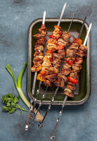 Bbq grilled meat pork, chicken and vegetable skewers on tray. Top view, flat layの写真素材