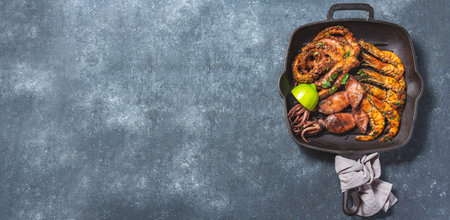 Grilled spimps, squids and octopus in cast iron grill panの写真素材