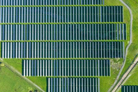 Solar panels on field in summer, aerial drone view