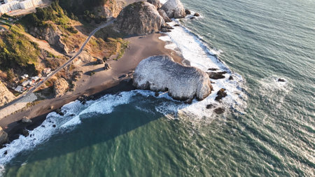 Large rocks natural monument Piedra de Iglecias Church stone on Chilean coast in Constitucion in sunset.の写真素材