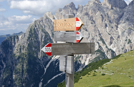 wooden signpost in the mountainsの写真素材