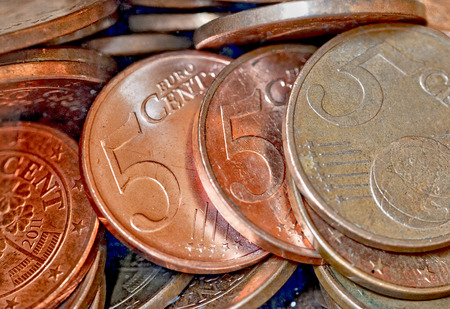 5 cent coins behind glass in a bottle
