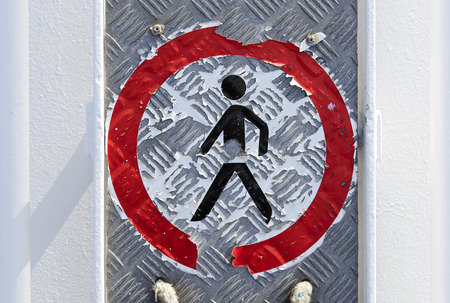 partly  peeled of label \"Keep off\" on a rippled metal sheetの写真素材