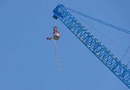 man jumping from a crane at the austrian national day, Vienna, 2013のeditorial素材
