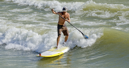 Men Surfing on the backwash of a ship on the river Danube Austriaのeditorial素材