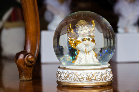 snow bowl with white angel with golden wingsの写真素材