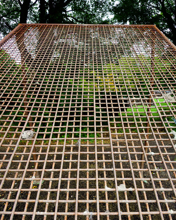 coarse soil sieve made from reinforcing steel standing betwen treesの写真素材
