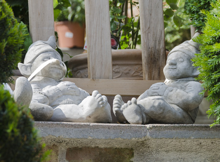 Two sleeping garden gnomes made from stone with price labelsの写真素材
