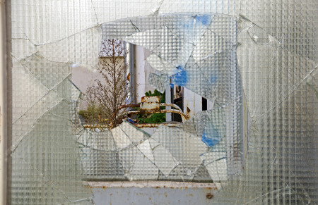 view through a hole in a pane of wired glass