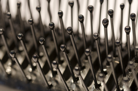 near view of spikes of a black plastic hair brush