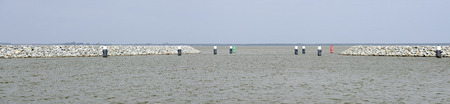 entrance to a harbour between two moles with bollards, Barther Bodden, Germanyの写真素材